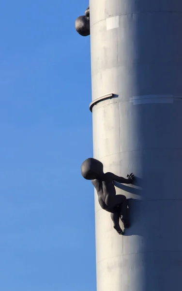 Zizkov Television Tower is a transmitter tower built in Prague between 1985 and 1992 with sculptures of babies crawling up and down the steel columns — Stock Photo, Image