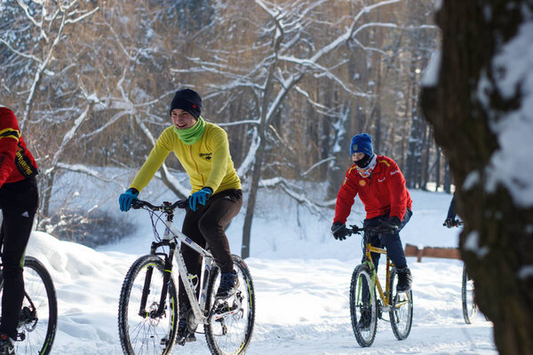 CHERKASSY, UKRAINE - JANUARY 28, 2017: The cycling of young guys in the winter park. Healthy way of life, on JANUARY 28 in CHERKASSY