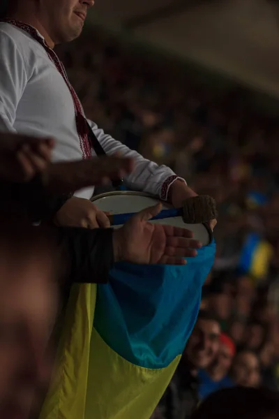 Ukrainian fan beats an Irish fans bass drum, outside Parc Olympique Lyonnais.