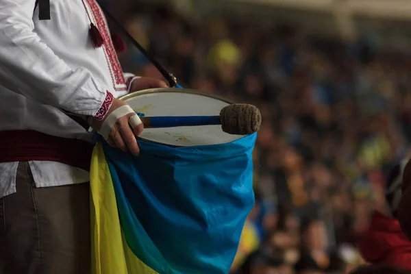 Ukrainian fan beats an Irish fans bass drum, outside Parc Olympique Lyonnais.