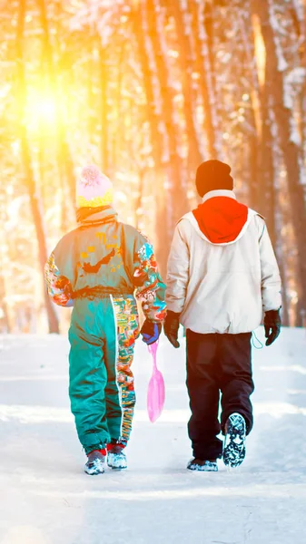 Boys enjoy a sleigh ride. Child sledding. Toddler kid riding a sledge. Children play outdoors in snow. Kids sled in Alps mountains in winter. Outdoor fun for family Christmas vacation. — Stock Photo, Image