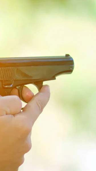 Man holding a gun in his hand ready to shoot — Stock Photo, Image