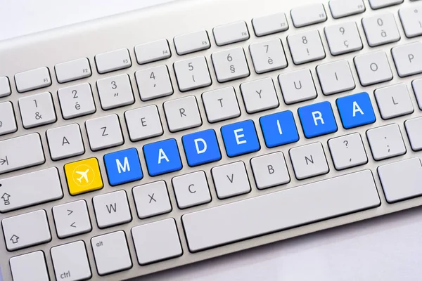 MADEIRA writing on white keyboard with a aircraft sketch