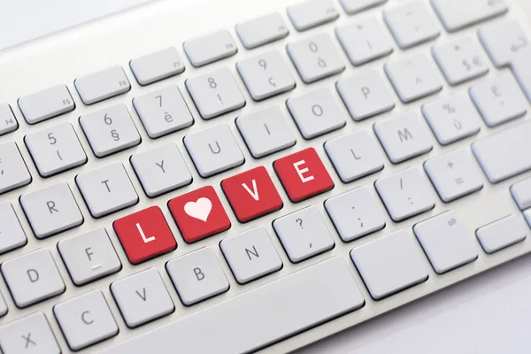 LOVE writing on white keyboard with a heart sketch