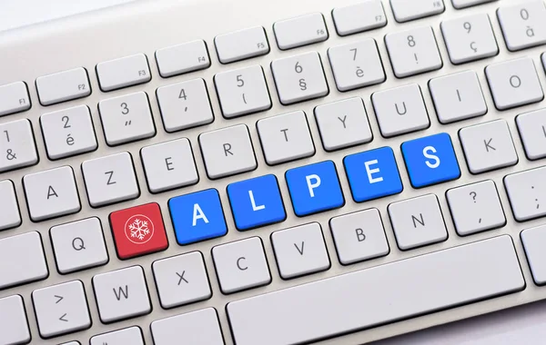 ALPES writing on white keyboard with a snowflake sketch