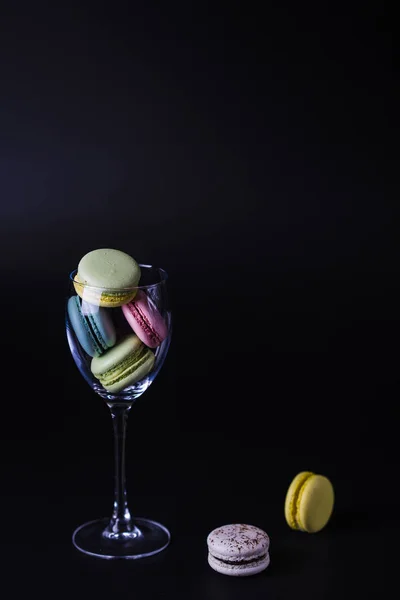 delicious French dessert macarons flying out from the glass