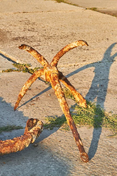 Old rusty four-legged anchor in the seaport Anapa