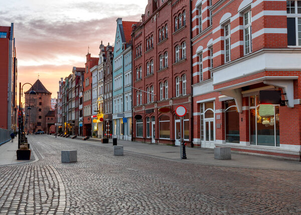 View of the old narrow medieval street at dawn. Gdansk. Poland.