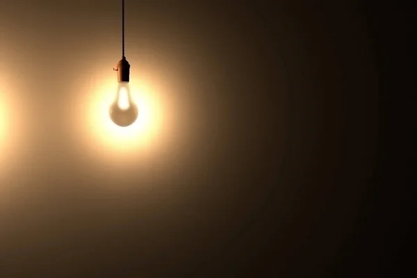 Light bulb glowing in the dark with place for text. 3d rendered — Stock Photo, Image