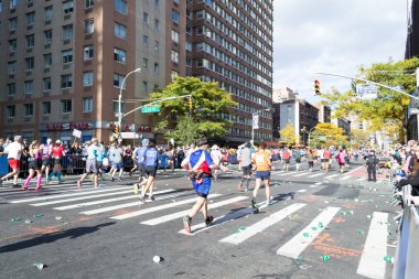 Marathon runners along first avenue in the NYC marathon 2016 clipart