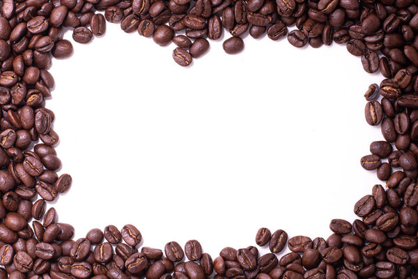 Square frame formed by coffee beans over a white background