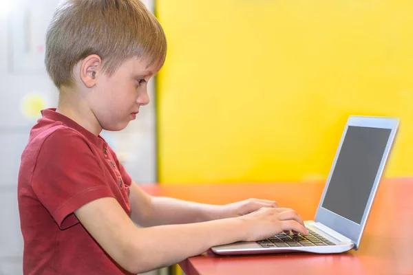 Young boy working on a laptop — Stock Photo, Image