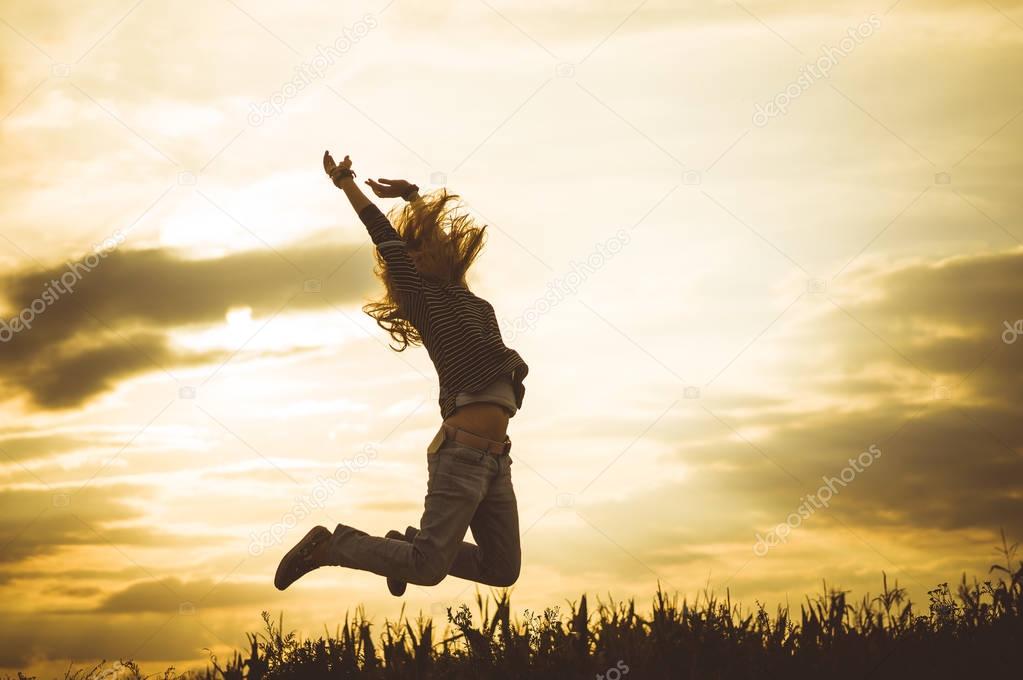woman jumping on meadow
