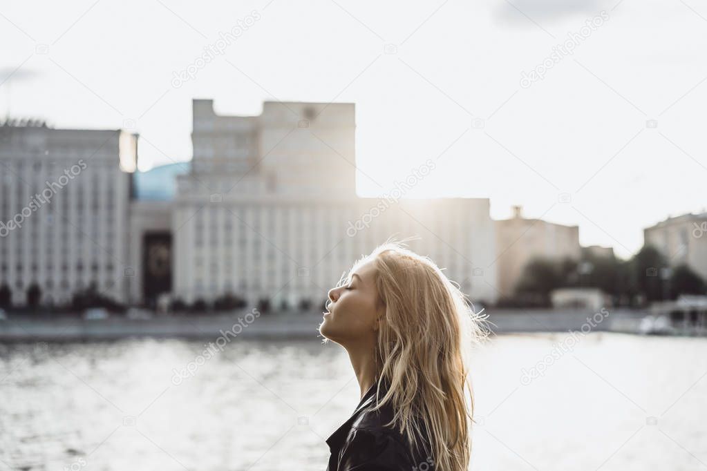 blonde woman posing at urban promenade