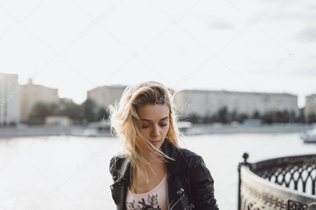 blonde woman posing at urban promenade