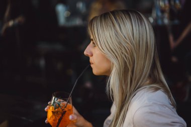 Kadın kokteyl içiyor.