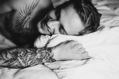 yatakta yastık üzerinde yatan adam