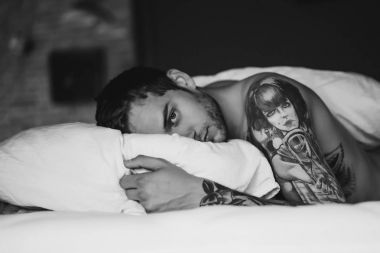 yatakta yastık üzerinde yatan adam