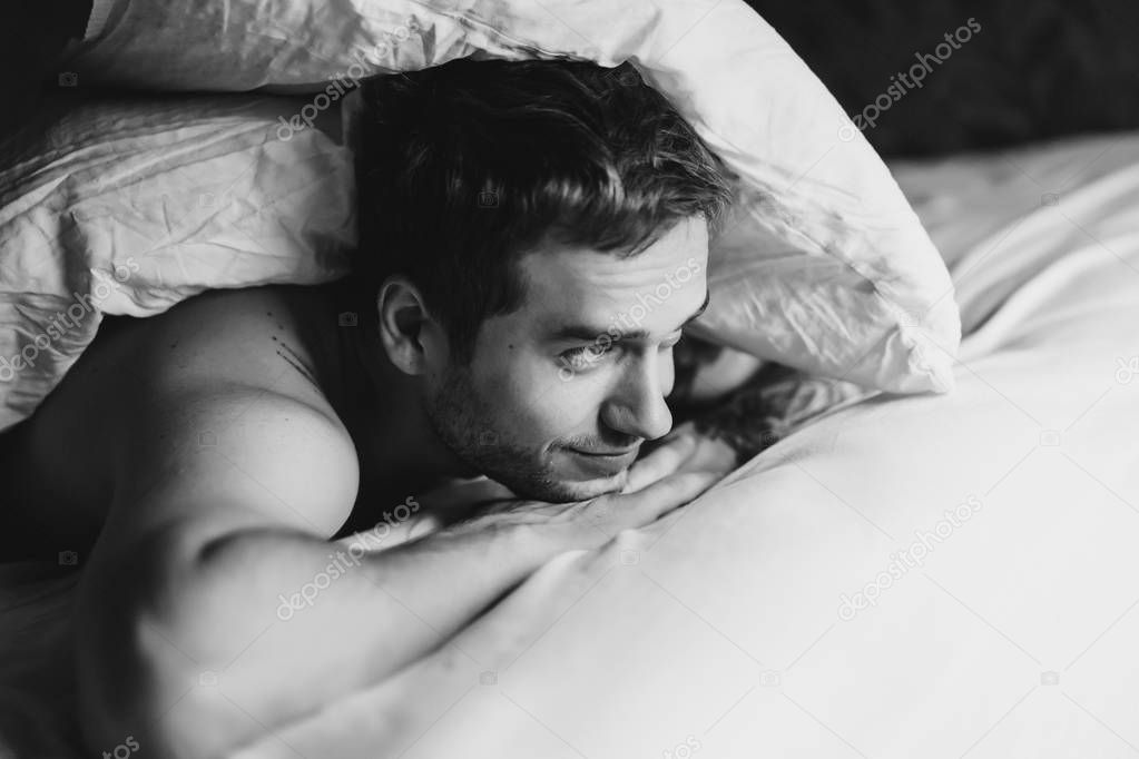 man with bristle lying in bed