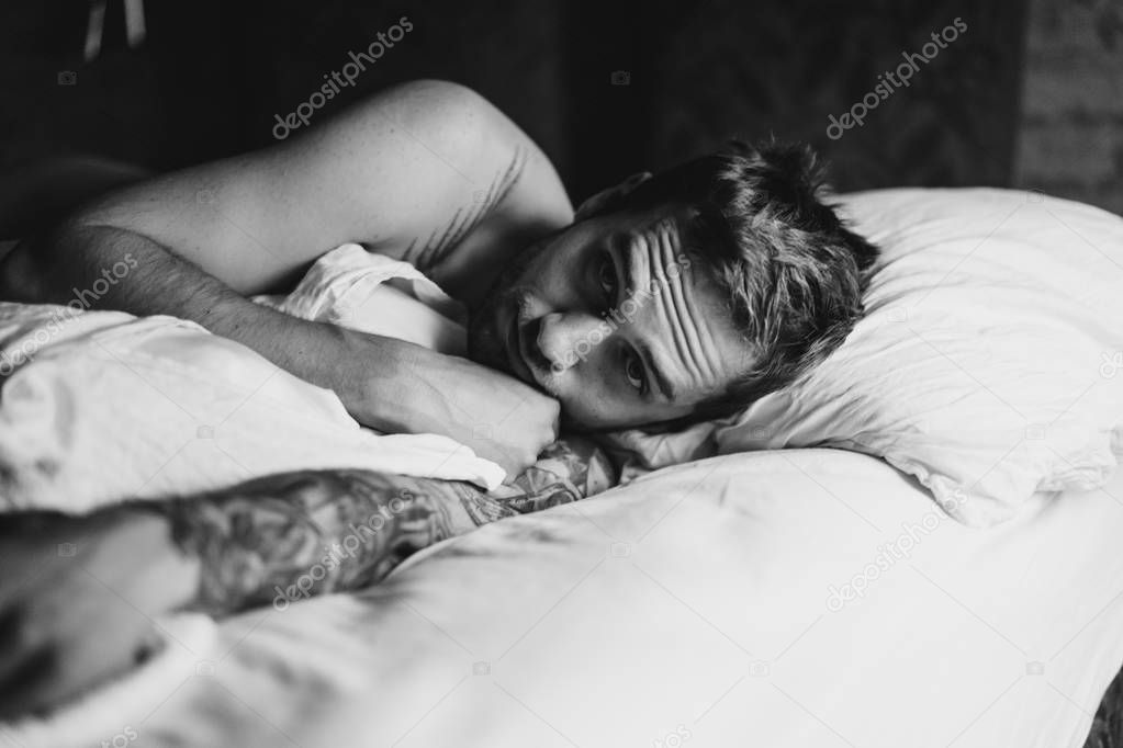 man lying on pillow on bed