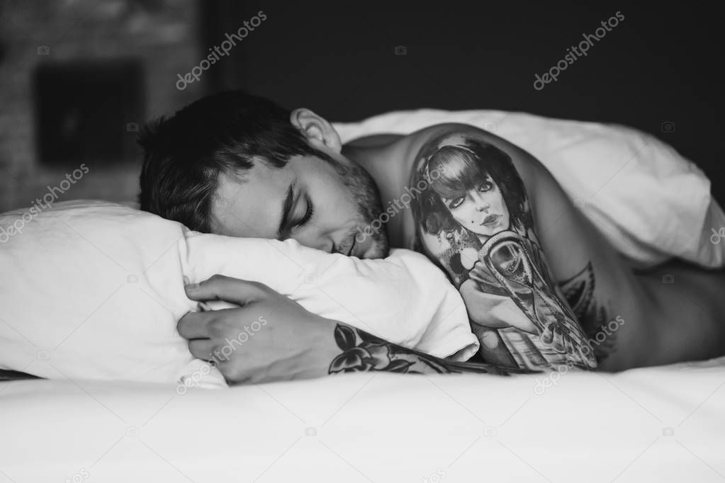 man sleeping on pillow on bed