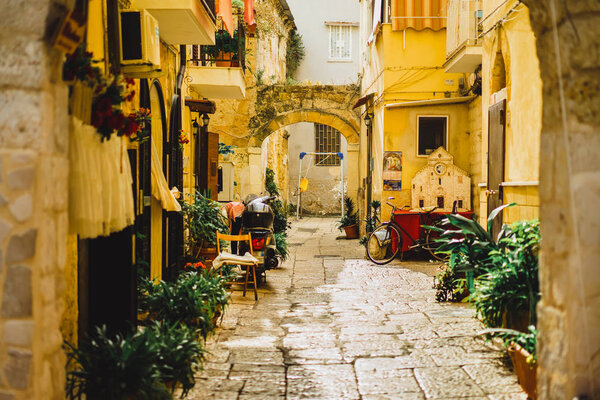 View of empty narrow street with old facades, Italy