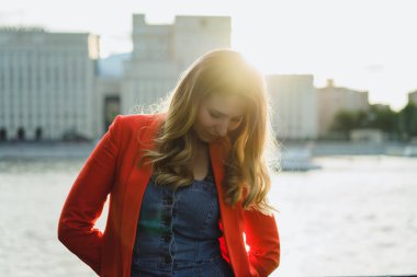 günbatımı zaman açık kırmızı ceketli sarışın genç kadın