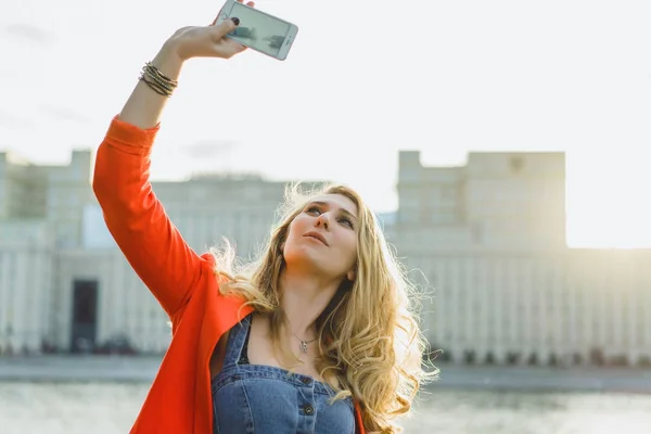 Young Blonde Woman Red Jacket Using Phone Outdoor — Stock Photo, Image