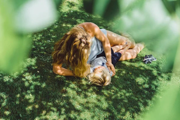 Schattige Blonde Jongen Met Jonge Moeder Liggen Gras Buiten Tuin — Stockfoto