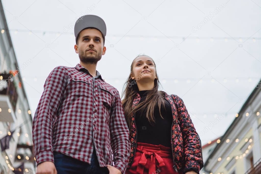 Stylish young couple posing on street