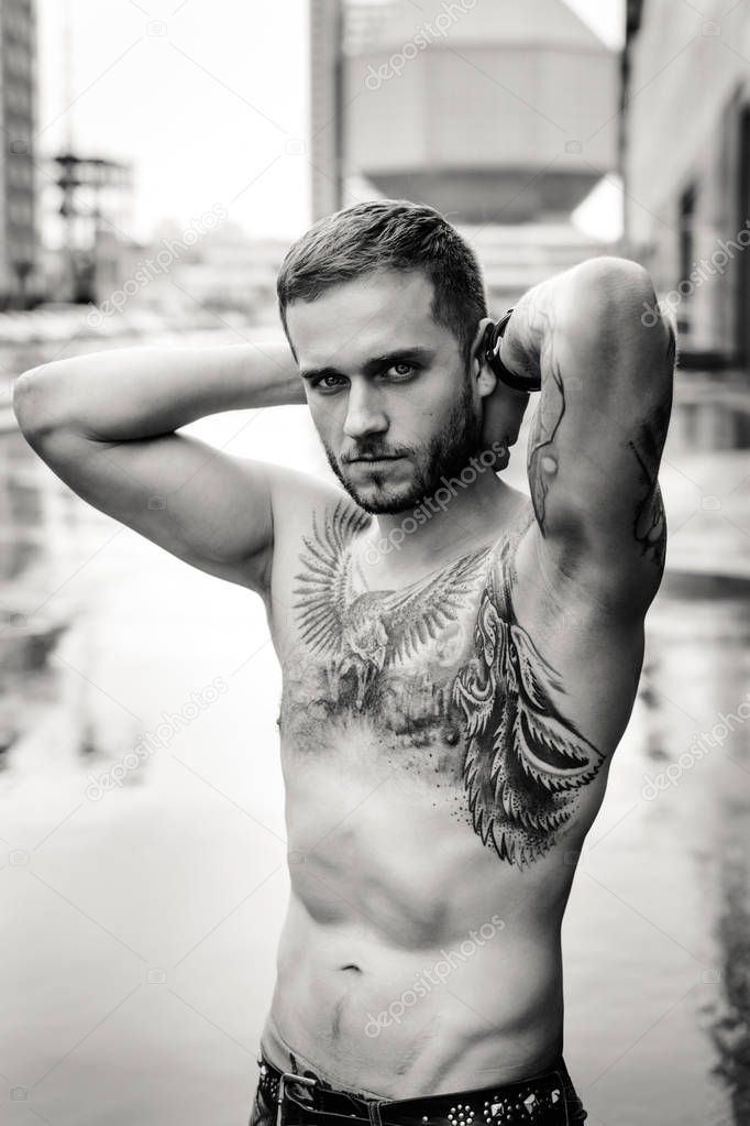Tattooed man with naked torso