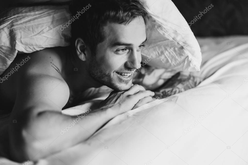 Man with bristle lying in bed
