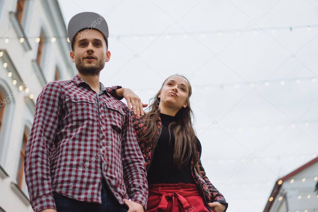 Stylish young couple posing on street