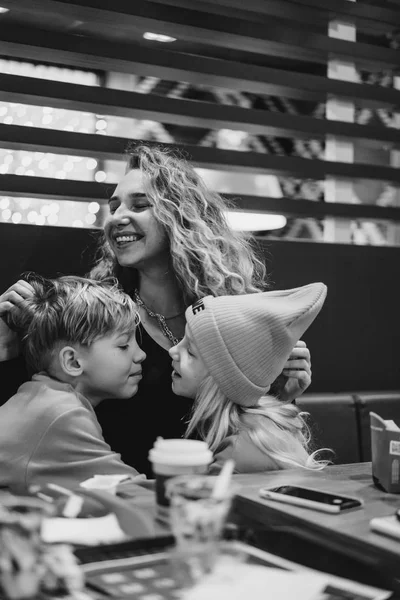 mom with kids at mcdonalds. Mom with children in a cafe.