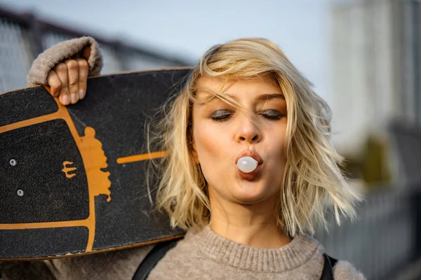 Urban stylish young girl walking with skateboard. Outdoors portr — Stock Photo, Image