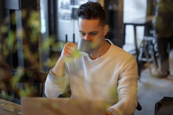 Young Man Drinks Tea Works Laptop Freelancer Working Cafe — 스톡 사진