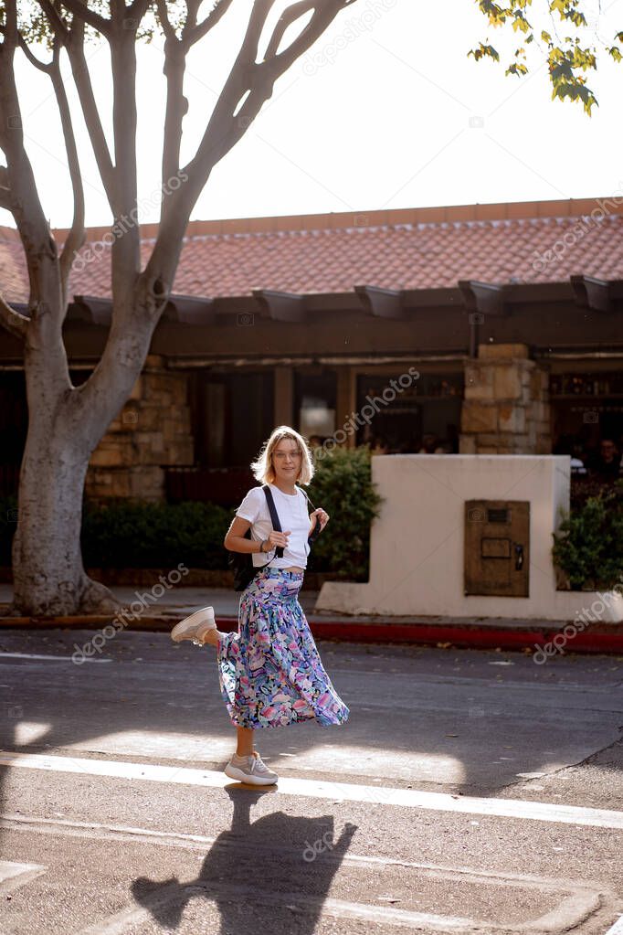 young woman walks the streets of Santa Barbara, USA