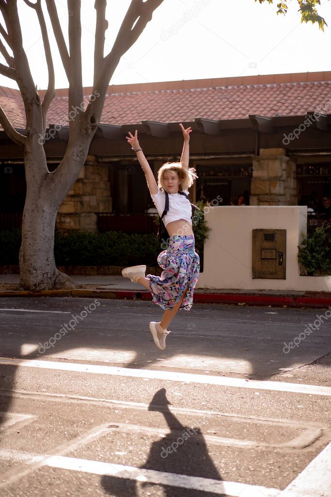 young woman walks the streets of Santa Barbara, USA