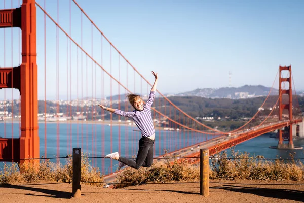 young woman on the background Golden Gate Bridge, San Francisco