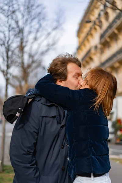 Loving couple on the street hugs and kisses. Paris.