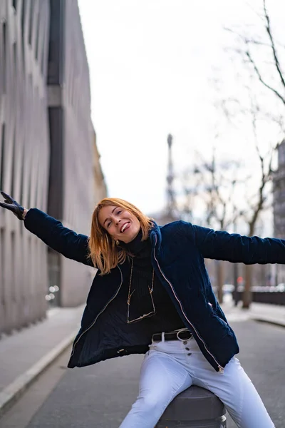 young beautiful woman walks in Paris. The concept of a happy travel photo.