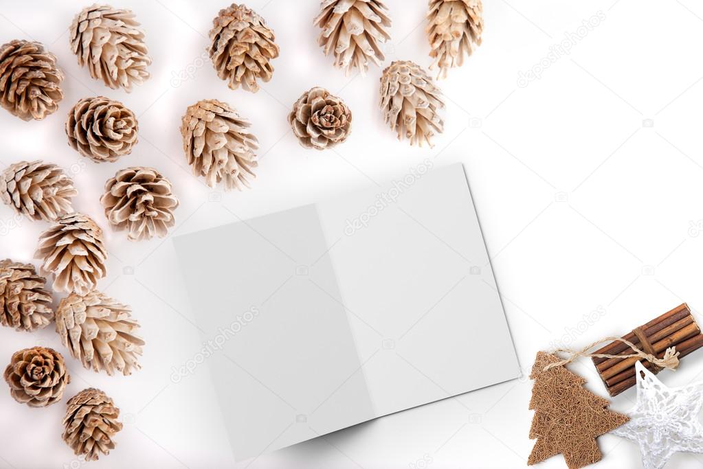 Christmas styled flat lay mockup desktop image with pine cones and open card