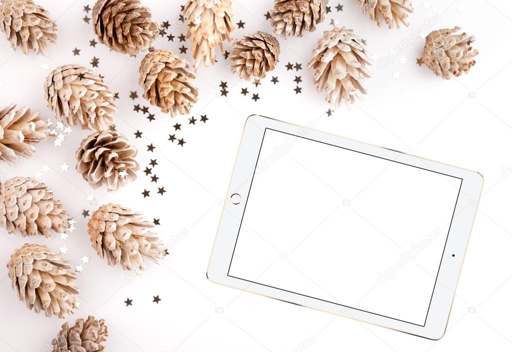 Christmas flat lay mockup desktop, pine cones & tablet on a white background