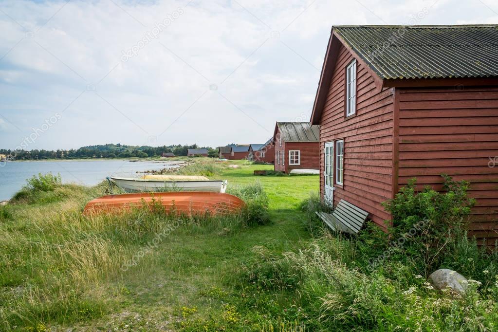 Idyllic small red Holiday cottages at a lake shore