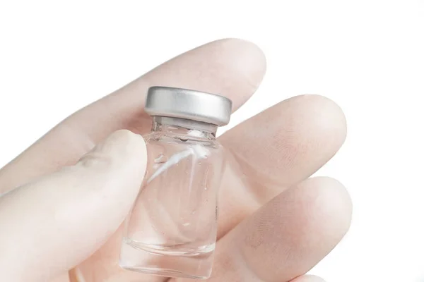 Hand with protective glove holding the vial — Stock Photo, Image