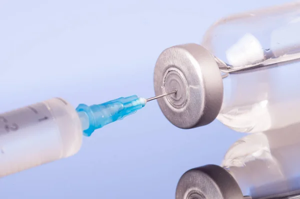 Medical syringe with the needle in the vial — Stock Photo, Image