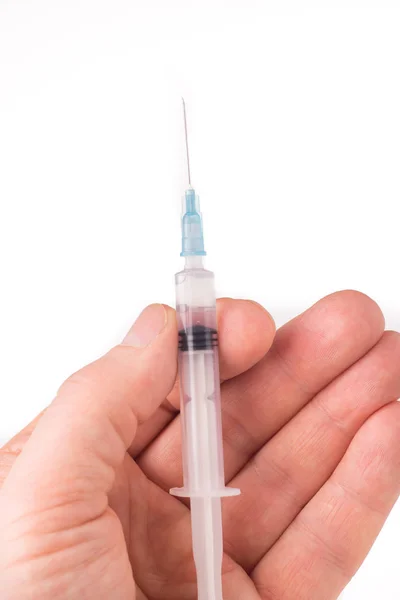 Hand holding a syringe — Stock Photo, Image