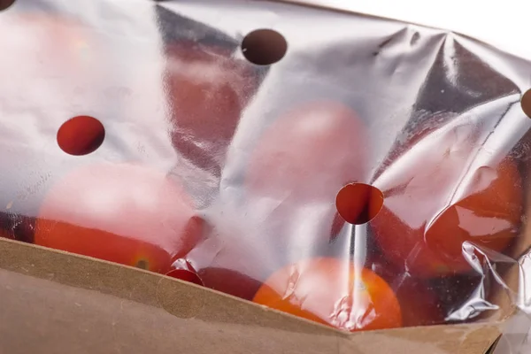 Organic tomato wrap in plastic — Stock Photo, Image