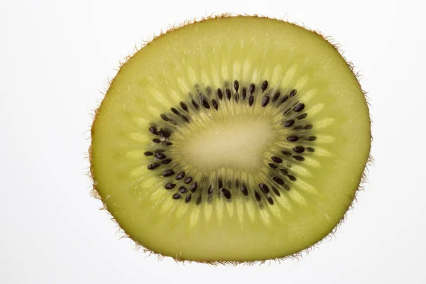 Scheibe Kiwi-Frucht in Gegenlicht geschnitten Foto-Aufnahme lizenzfreie Stockfotos