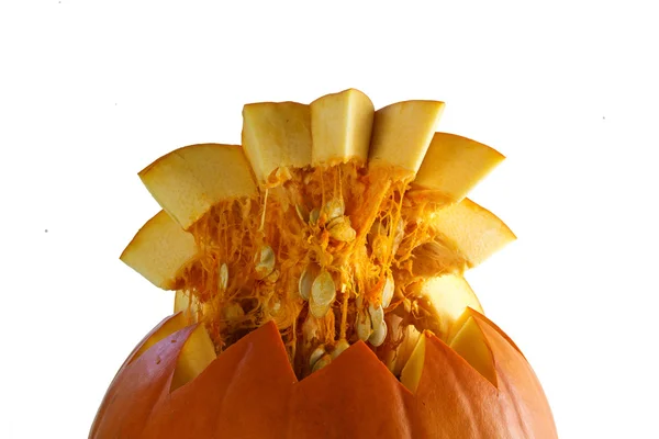 Pumpkin seeds on the lid of a cut open halloween pumpkin isolated on white — Stock Photo, Image